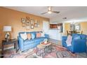 Comfortable living room with blue sofa, decorative pillows, and a stylish rug with access to the Kitchen at 5757 W Eugie Ave # 2081, Glendale, AZ 85304