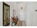 Bright entryway featuring neutral walls, tiled floor, and elegant decor at 5867 W Cochise Dr, Glendale, AZ 85302