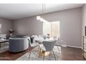 Dining area with a modern light fixture and plush seating at 6618 S 54Th Ln, Laveen, AZ 85339