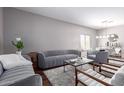 Modern living room featuring plush seating, stylish decor, and ample natural light at 6618 S 54Th Ln, Laveen, AZ 85339
