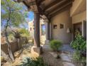 Front porch featuring desert landscaping, wood columns, and a walkway leading up to an earth tone colored home at 7373 E Clubhouse Dr # 24, Scottsdale, AZ 85266