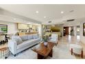 Bright and airy living room with modern decor, tile flooring, and seamless flow to kitchen at 7725 N Via De Fonda --, Scottsdale, AZ 85258