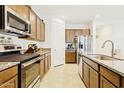 Well-lit kitchen with stainless appliances, granite countertops, and dark wood cabinetry at 786 W Palo Verde W Dr, Casa Grande, AZ 85122