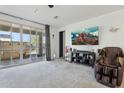 Bright living room featuring large glass doors, neutral walls, and plush carpeting at 786 W Palo Verde W Dr, Casa Grande, AZ 85122