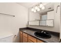 Standard bathroom with a dark countertop and a framed mirror and vanity lighting at 8155 E Roosevelt St # 204, Scottsdale, AZ 85257