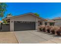 Spacious two-car garage with modern doors and concrete driveway, adjacent to manicured landscaping at 8238 E San Miguel Ave, Scottsdale, AZ 85250