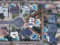Aerial view showcases the property's layout, including the pool, privacy landscaping, and its location on a cul-de-sac at 8438 E Stella Ln, Scottsdale, AZ 85250