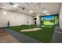 Large recreation room with a golf simulator, sand trap, and putting green for entertainment at 8602 E Gary Rd, Scottsdale, AZ 85260