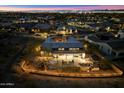 Aerial view of the home at night highlighting an outdoor dining area and fire pit at 9539 S 13Th Way, Phoenix, AZ 85042