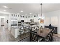 Open concept kitchen with white cabinetry, stainless steel appliances, granite countertops, and adjacent dining area at 9929 E South Bend Dr, Scottsdale, AZ 85255