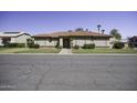 Lovely single-story home with a well-manicured front yard and tiled roof at 1214 E Clearview Dr, Casa Grande, AZ 85122