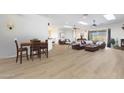 Open-concept living area boasts wood floors, skylights, fireplace, and comfortable seating at 14442 W Lexington Ave, Goodyear, AZ 85395