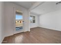 Bright living room with wood-look tile flooring and lots of natural light at 14761 W Tether Trl, Surprise, AZ 85387