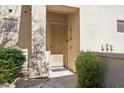 Inviting front entry featuring a modern door, stylish lighting, and desert landscaping at 16420 N Thompson Peak Pkwy # 2091, Scottsdale, AZ 85260