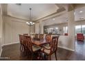 Inviting dining room featuring a large table and chairs with views into the living room and backyard at 1712 W Aloe Vera Dr, Phoenix, AZ 85085