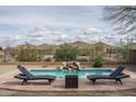 Inviting pool with waterfall feature and desert mountain views at 1712 W Aloe Vera Dr, Phoenix, AZ 85085