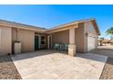 Inviting front patio features travertine tile, desert rock and quaint blue chairs and table at 1715 Leisure World --, Mesa, AZ 85206