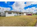 Charming single-story home featuring a welcoming porch, a well-maintained lawn, and an attached garage with an open carport at 1840 E Jarvis Ave, Mesa, AZ 85204