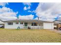 Charming single-story home featuring a welcoming porch, a well-maintained lawn, and an attached garage with an open carport at 1840 E Jarvis Ave, Mesa, AZ 85204