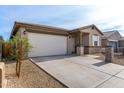 Attractive single-story house with a large driveway leading to a two-car garage at 1971 S 241St Dr, Buckeye, AZ 85326