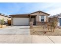 Inviting single-story home with a well-kept front yard and a spacious two-car garage at 1971 S 241St Dr, Buckeye, AZ 85326