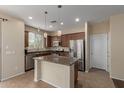 Bright kitchen featuring an island, stainless steel appliances, and a window over the sink at 21145 E Via De Olivos --, Queen Creek, AZ 85142