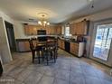 Spacious kitchen featuring ample cabinetry and counter space, plus a black appliance package at 2515 E Mcarthur Dr, Tempe, AZ 85288