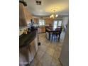 Cozy kitchen with tile flooring, pendant lighting, and an adjacent dining area at 2515 E Mcarthur Dr, Tempe, AZ 85288