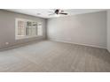 A spacious bedroom is bright with a large window that has plantation shutters and neutral colored walls at 2929 E Binner Dr, Chandler, AZ 85225