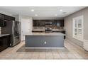 A well-lit kitchen featuring stainless steel appliances, granite countertops, tile backsplash, and a spacious center island at 2929 E Binner Dr, Chandler, AZ 85225