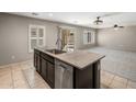 An island with sink and dishwasher is featured, while a living space extends to the right, with large windows at 2929 E Binner Dr, Chandler, AZ 85225