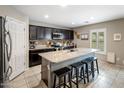 Stylish kitchen with a spacious granite island, dark cabinetry, stainless steel appliances, and tile flooring at 2929 E Binner Dr, Chandler, AZ 85225