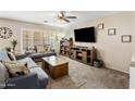 Cozy living room features neutral walls, carpet, plantation shutters, ceiling fan, and comfortable furniture at 2929 E Binner Dr, Chandler, AZ 85225