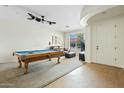 Open-concept living room featuring a pool table, carpet, and ample natural light at 2994 E Sports Ct, Gilbert, AZ 85298