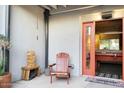 Outdoor patio area with an Adirondack chair and a view into the game room through sliding doors at 3041 S Country Club Way, Tempe, AZ 85282