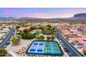 Aerial view of a vibrant community featuring a pool, tennis courts, and mountain views at 3301 S Goldfield Rd # 3005, Apache Junction, AZ 85119