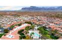 Aerial view of a luxurious community showcasing a pool, palm trees, and lush landscaping at 3301 S Goldfield Rd # 3005, Apache Junction, AZ 85119