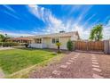 Well-maintained home with manicured lawn, desert landscaping, and gated driveway at 332 N 25Th St, Mesa, AZ 85213