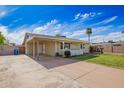 Home with carport and tidy front yard featuring mature palm trees and a driveway at 332 N 25Th St, Mesa, AZ 85213