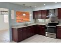 Modern kitchen with stainless steel appliances, granite countertops, and dark wood cabinets at 332 N 25Th St, Mesa, AZ 85213