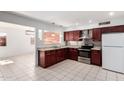A stylish kitchen featuring granite counters, stainless steel appliances, and tile floors at 332 N 25Th St, Mesa, AZ 85213