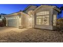 Charming home exterior with well-maintained landscaping, a two-car garage, and inviting front entrance at 3522 E Edna Ave, Phoenix, AZ 85032