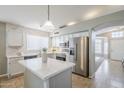 Modern kitchen features stainless steel appliances, sleek white cabinetry and a functional center island at 3522 E Edna Ave, Phoenix, AZ 85032