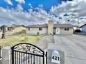 Street view of home with front yard, gate, and extended driveway at 421 E Desert Dr, Phoenix, AZ 85042