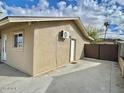 Side exterior of home with white doors and attached air conditioning unit at 421 E Desert Dr, Phoenix, AZ 85042