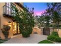 Beautiful outdoor patio features stone pavers and a lovely view through a set of french doors at 42171 N Saguaro Forest Dr, Scottsdale, AZ 85262