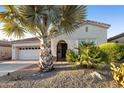 Desert home with an arched entryway, desert landscaping, and two-car garage at 4320 E Ficus Way, Gilbert, AZ 85298