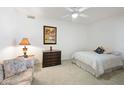 Cozy bedroom with neutral carpeting and a ceiling fan, perfect for relaxation at 511 W Cherrywood Dr, Sun Lakes, AZ 85248