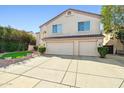 Inviting two-story home features a three-car garage and a well-maintained, charming front yard at 5291 W Angela Dr, Glendale, AZ 85308