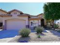 Front exterior showcasing desert landscaping and a neutral color scheme at 7741 E Journey Ln, Scottsdale, AZ 85255